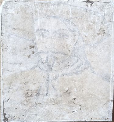 a stone plaque with a drawing of a bird on it