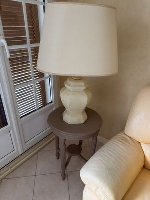 a lamp that is sitting on a table next to a couch