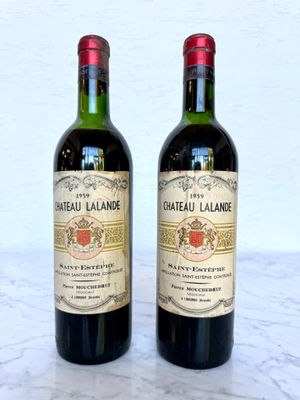 two bottles of wine sitting next to each other on a table