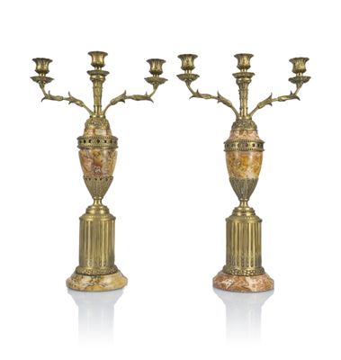 pair of antique brass candelabs on marble pedestals
