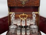 an image of a wooden case with a set of glassware in it
