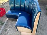 a blue couch and a red crate in a yard