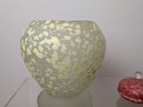 a glass vase sitting on top of a glass table