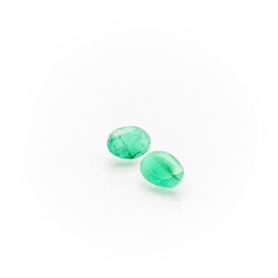 a pair of green quartz faceted tear shaped beads on a white background