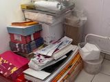 a stack of boxes and boxes on the floor of a bathroom