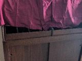 a wooden chest with a red cloth on top