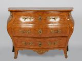 a wooden chest of drawers with a marble top