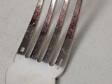 a fork that is sitting on top of a piece of paper