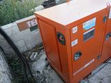 an orange machine sitting on the side of the road