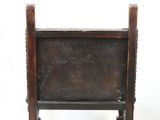 a small wooden chair with a wooden seat on it