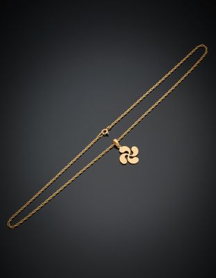 un collier plaqué or orné d'un pendentif en forme de cœur sur fond noir