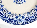 a blue and white plate sitting on a white table
