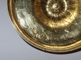 an image of a gold plate with a clock on it