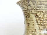 a vase that is sitting on a white surface