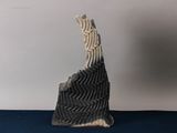 a black and white sculpture of a bird on a blue surface