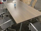 a table with chairs and a bottle of water on it