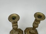 two candles that are sitting on a white table
