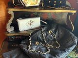 several purses are stacked on top of each other on a shelf