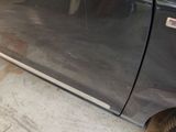 a close up of a car ' s door handle and tire
