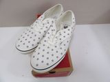 pair of white and grey polka dot shoes on a box