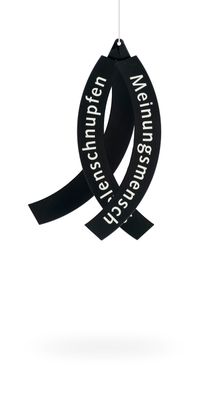 a black ribbon hanging from a string on a white background