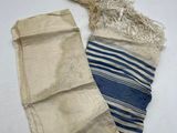 a pair of blue and white striped bags sitting on top of a white table