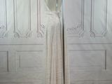 a dress on a mannequin stand in front of a wall
