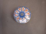 a blue and white plate with orange flowers on it