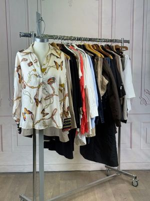 a lot of clothes hanging on a rack in a room