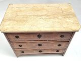 a small wooden chest of drawers with a marble top