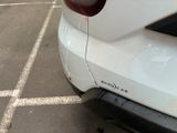 a white car parked in a parking lot next to a parking meter