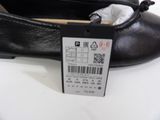 a close up of a pair of black shoes with a price tag