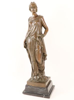 bronze statue of a woman holding a flower on a marble base