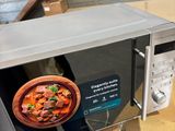 a microwave that has a bowl of food inside of it