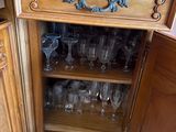 a wooden cabinet with a bunch of wine glasses on it