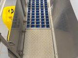 a metal door with blue tiles on it in a room