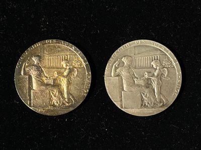 two gold coins with a picture of a man and a woman on them