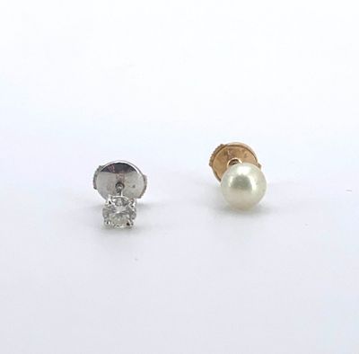 une paire de boucles d'oreilles clous ornées de diamants et de perles, sur fond blanc