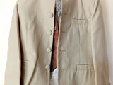 jacket on a hanger on a white wall with a red tie