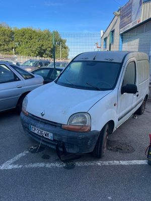 a white van parked in a parking lot next to other cars