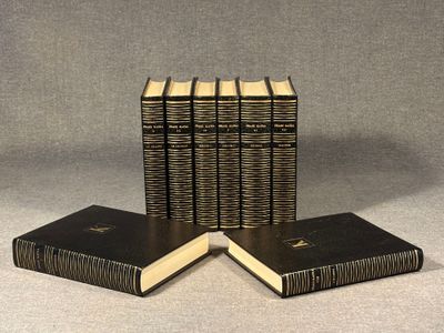 four books are stacked on top of each other on a table