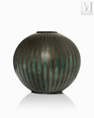 a green vase that is sitting on a white surface