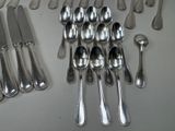 a lot of silver spoons and knives on the table