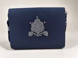 a close up of a blue purse with a skull on it