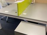a desk with a chair and a desk top with a yellow divider