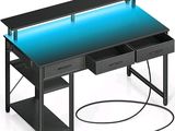 a computer desk with a blue light under it