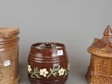 three different types of ceramic containers sitting next to each other on a gray surface