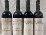 four bottles of wine are lined up on a table