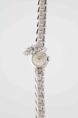 an image of a woman ' s wrist watch with a dragon on it