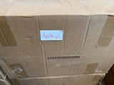 a cardboard box with a sticker on it sitting on the floor